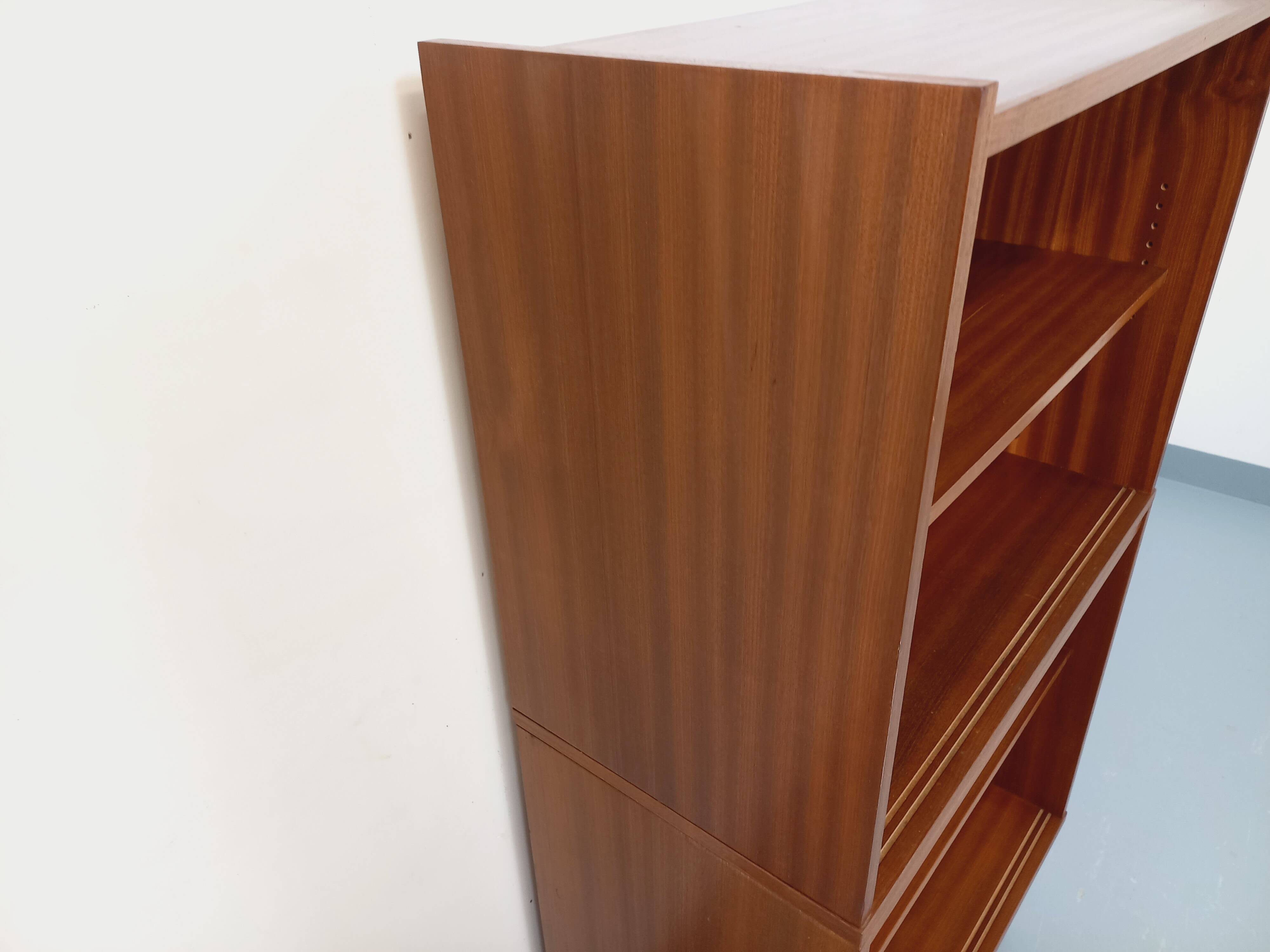 Vintage wooden bookshelf in teak style from the 1960s.