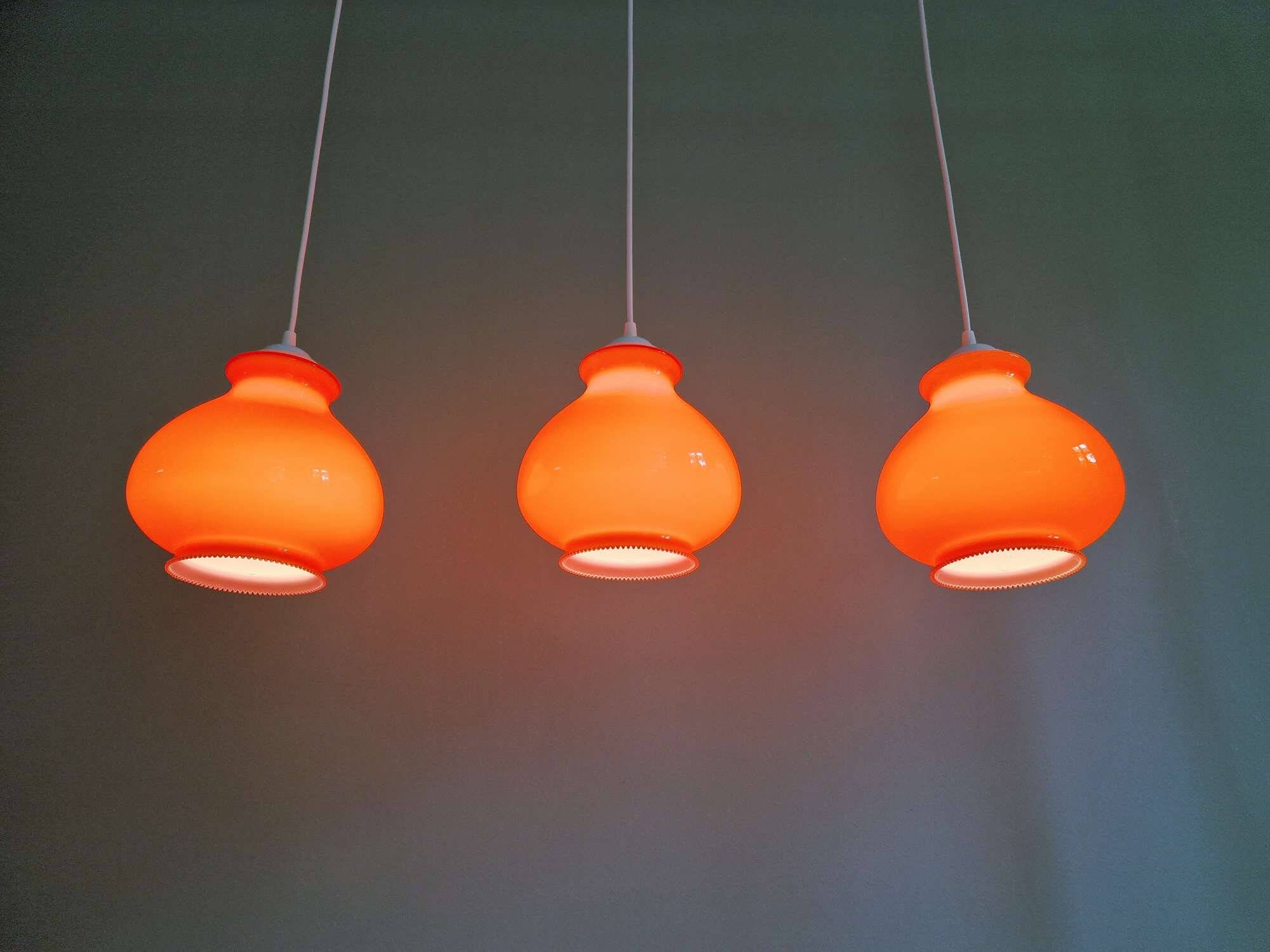 Trio of vintage orange opaline pendant lights, 1960-70