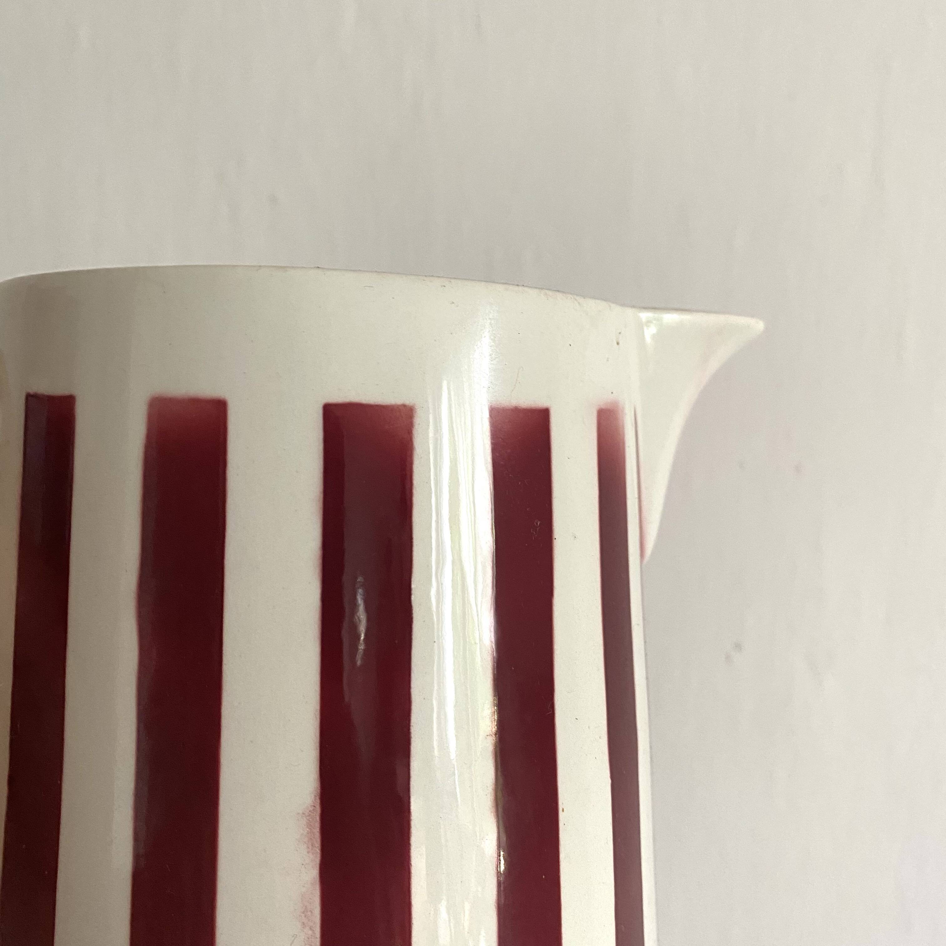 Antique earthenware pitcher with burgundy stripes