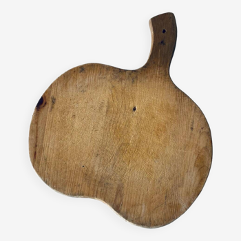 Old wooden apple-shaped cutting board