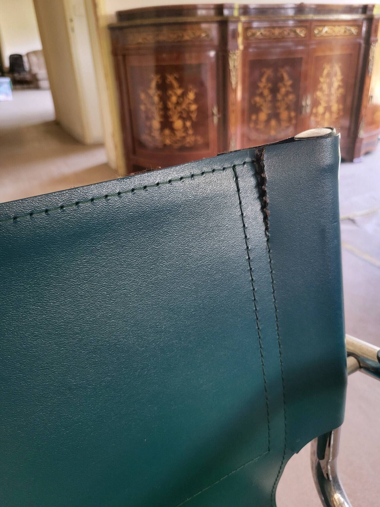 4 vintage Italian armchairs in green leather and chrome metal.
