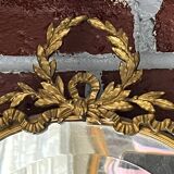 Beveled oval mirror in gilded bronze