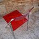 Red Plexiglas folding chair