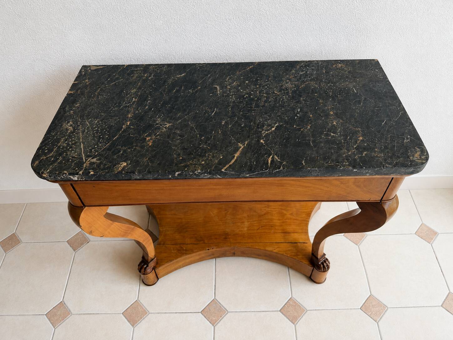 French console from the 19th century in cherry wood and black marble, with claw feet.