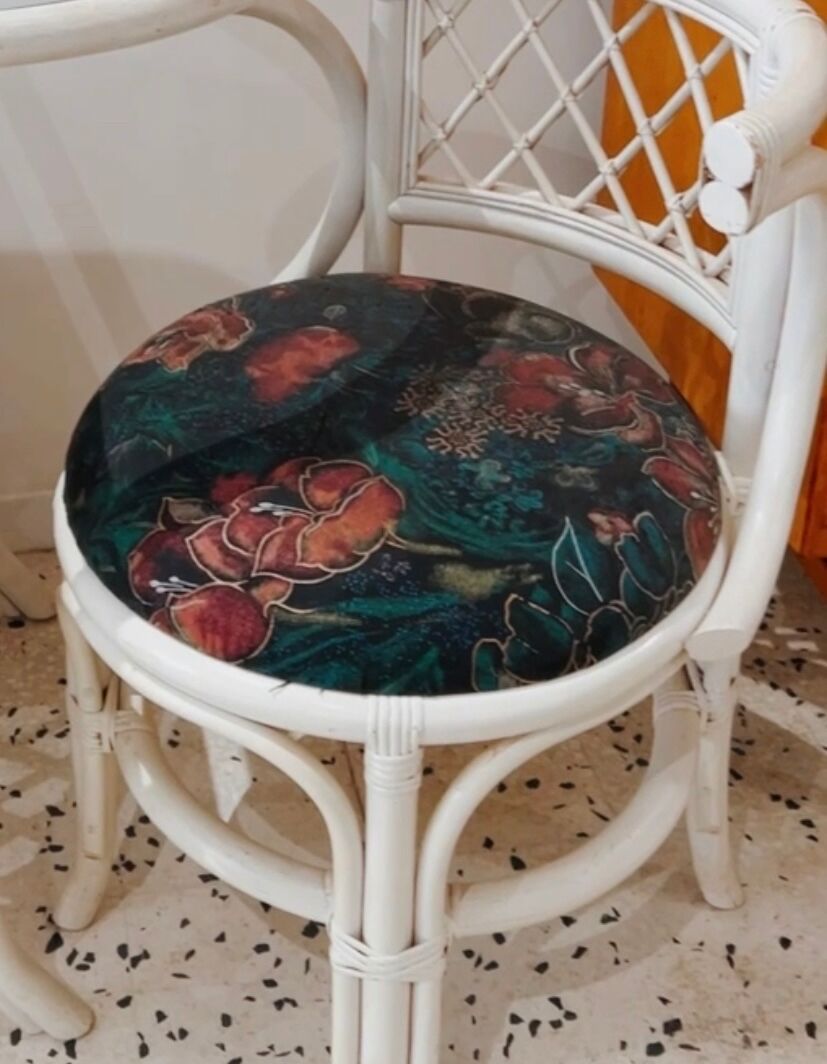 Rattan head-to-head table with vintage armchairs