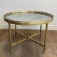 Brass coffee table with a vintage mirror top from the Baguès house.