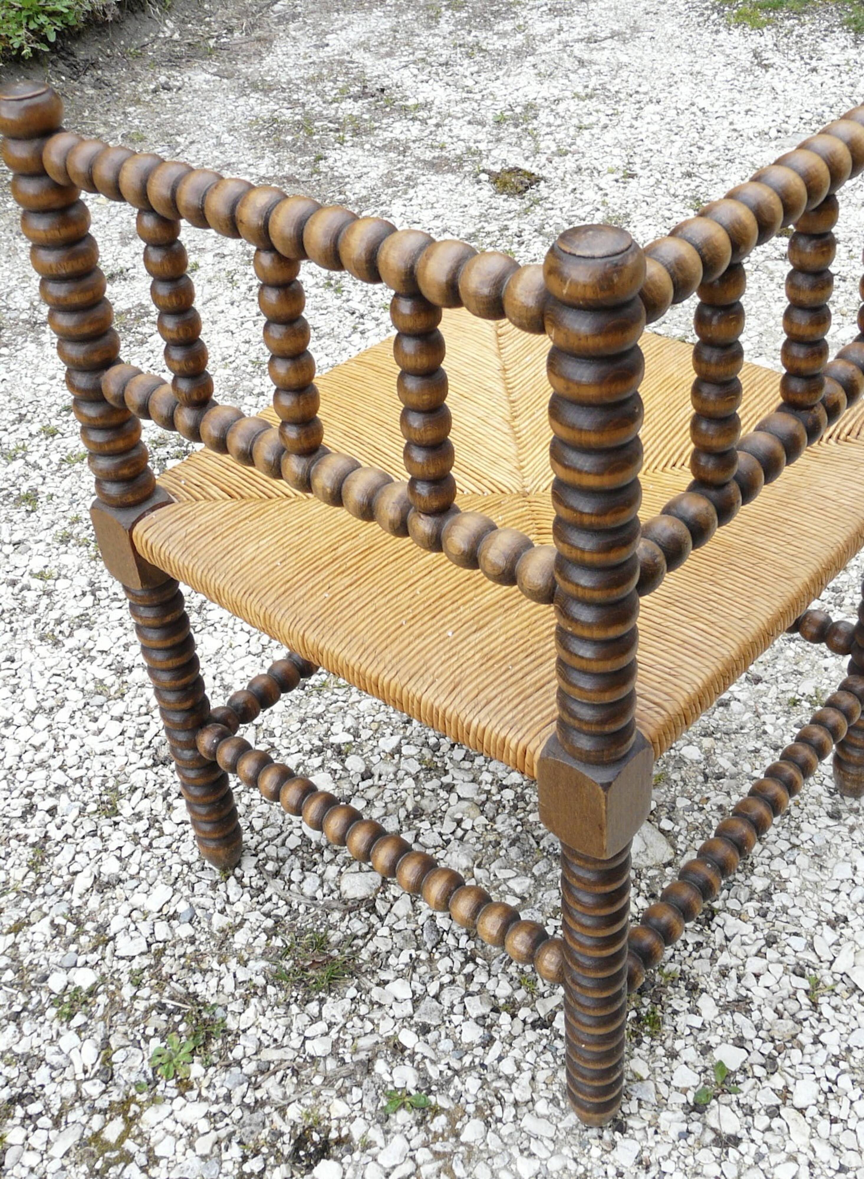 Turned wood straw corner armchair