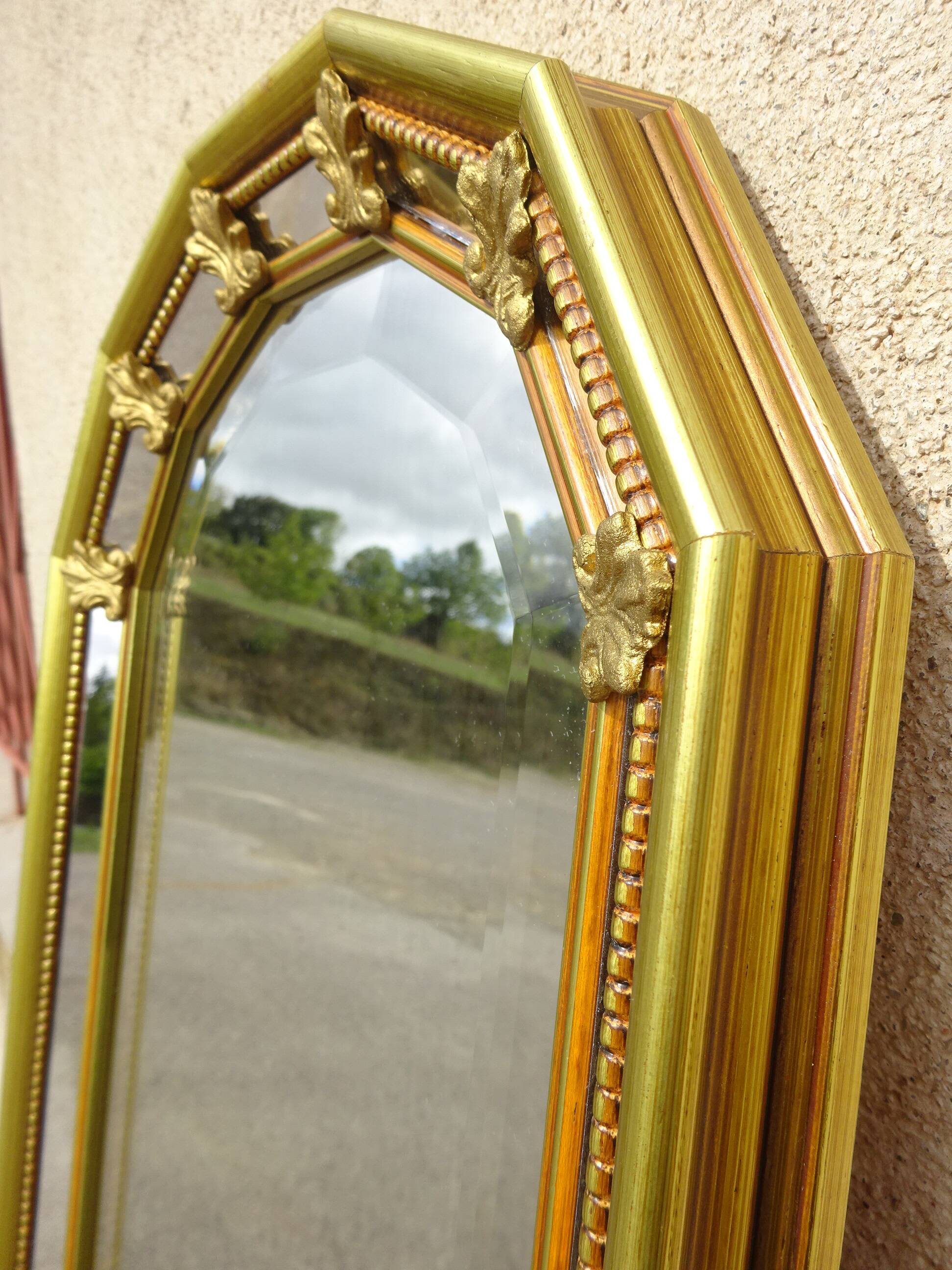 Vertical mirror, gold frame with beading.