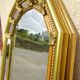 Vertical mirror, gold frame with beading.