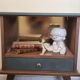 Renovated vintage bedside table in wood, with tapered legs – Matt green & gold background