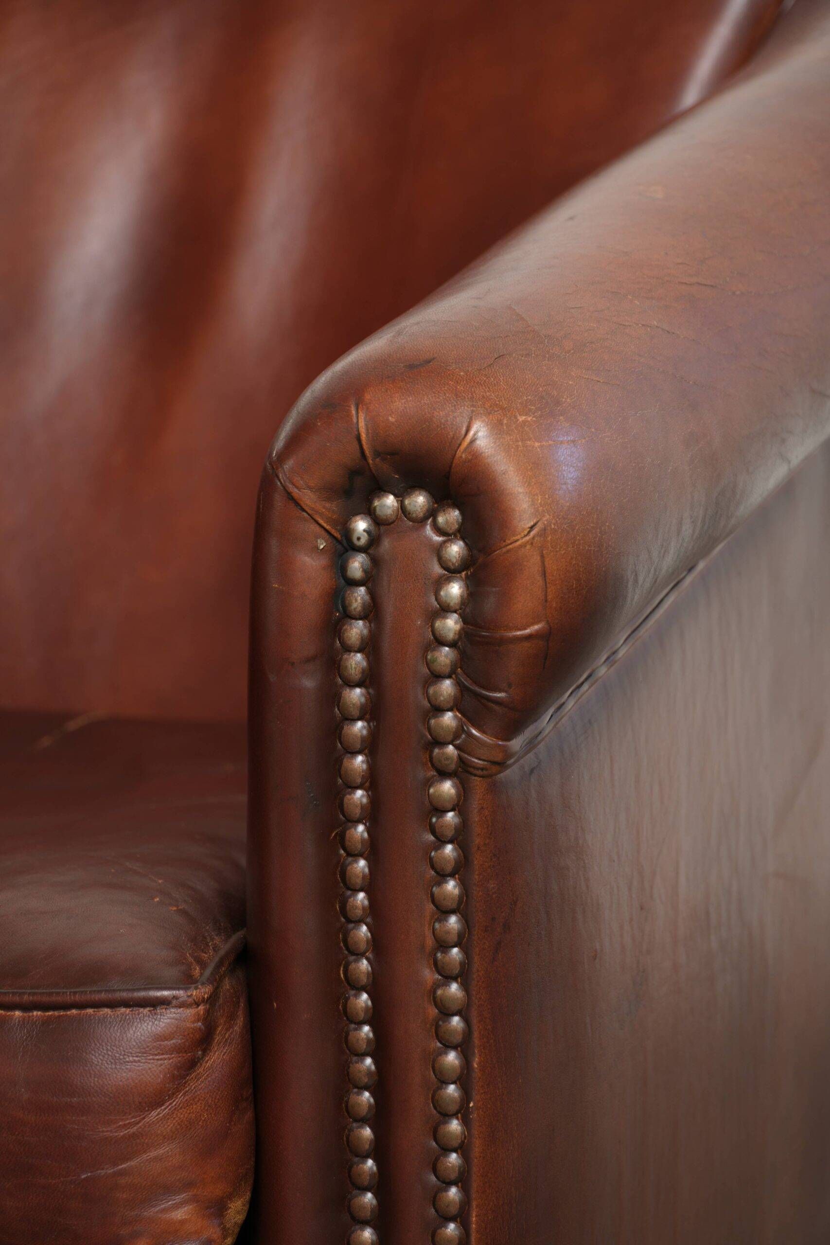 Set of 2 sheepskin club armchairs in a dark cognac colour