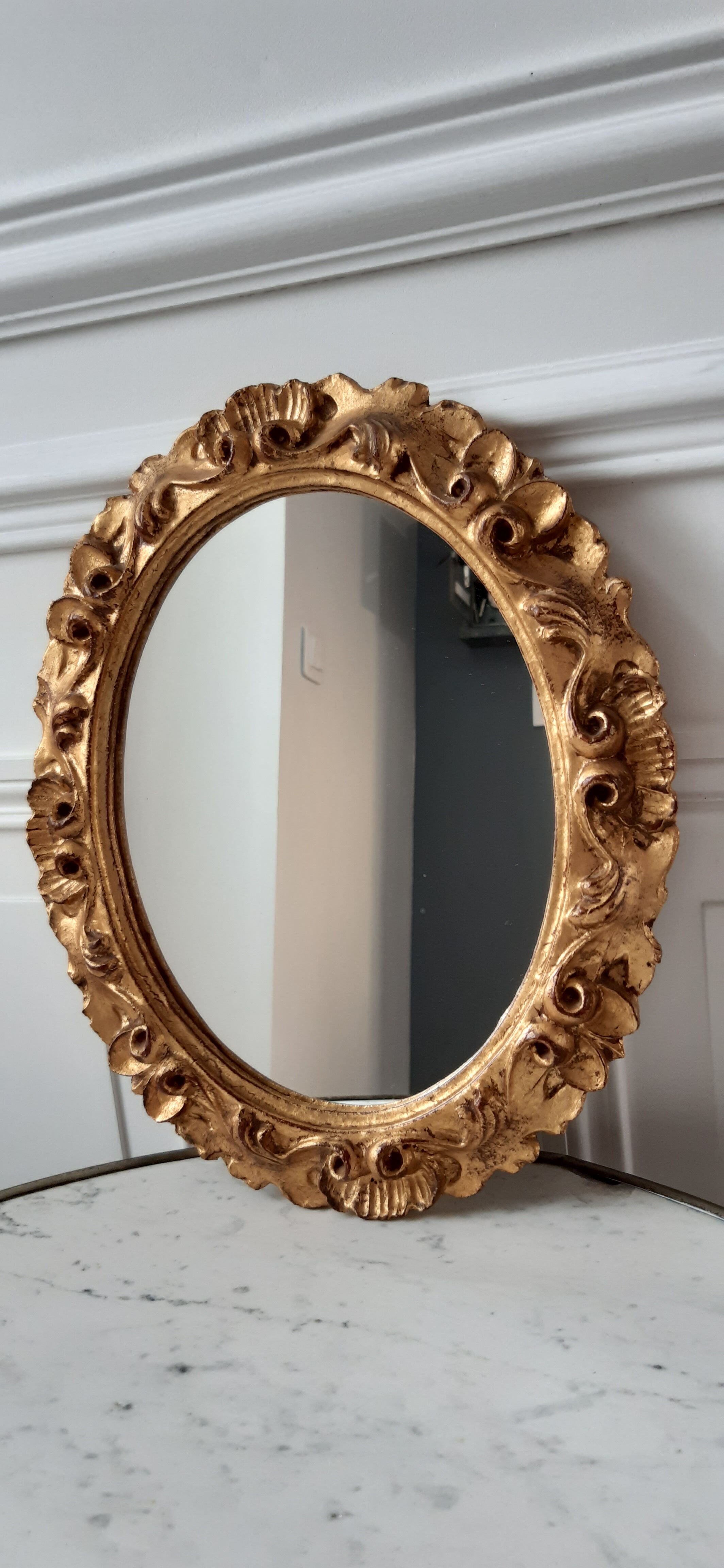 Old mirror in gilded wood late nineteenth