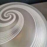 Frosted glass globe ceiling light with spiral patterns.
