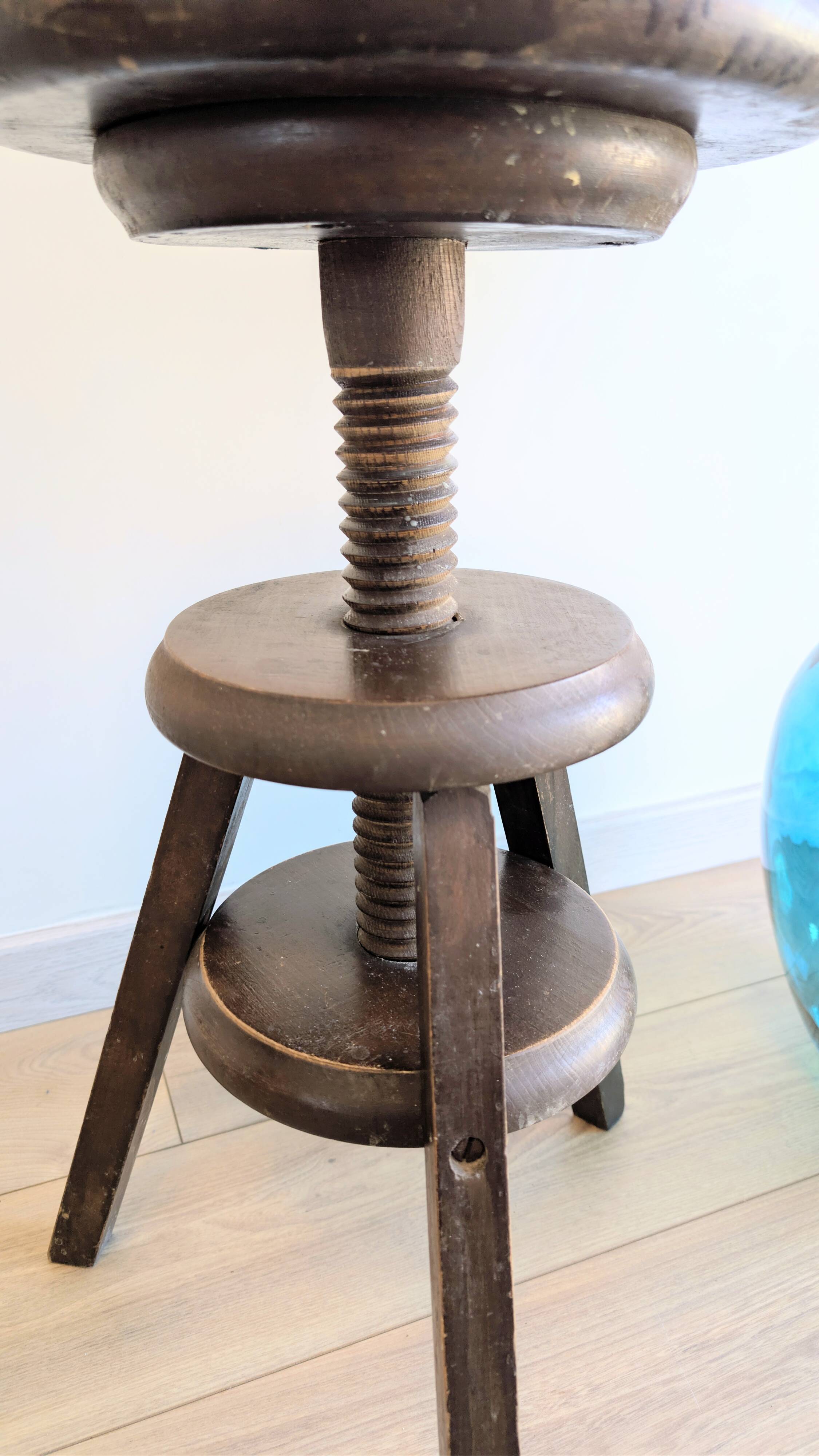 Antique wooden watchmaker's stool with screws, patinated wood.