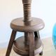 Antique wooden watchmaker's stool with screws, patinated wood.