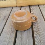 Brown sandstone cup with white spots