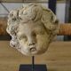 Reconstituted stone sculpture in antique style from the 20th century.