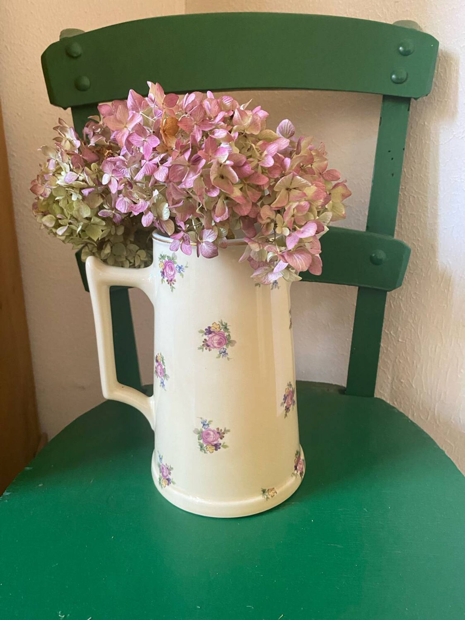 Old flowery and gilded pitcher.