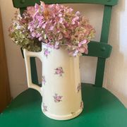 Old flowery and gilded pitcher.