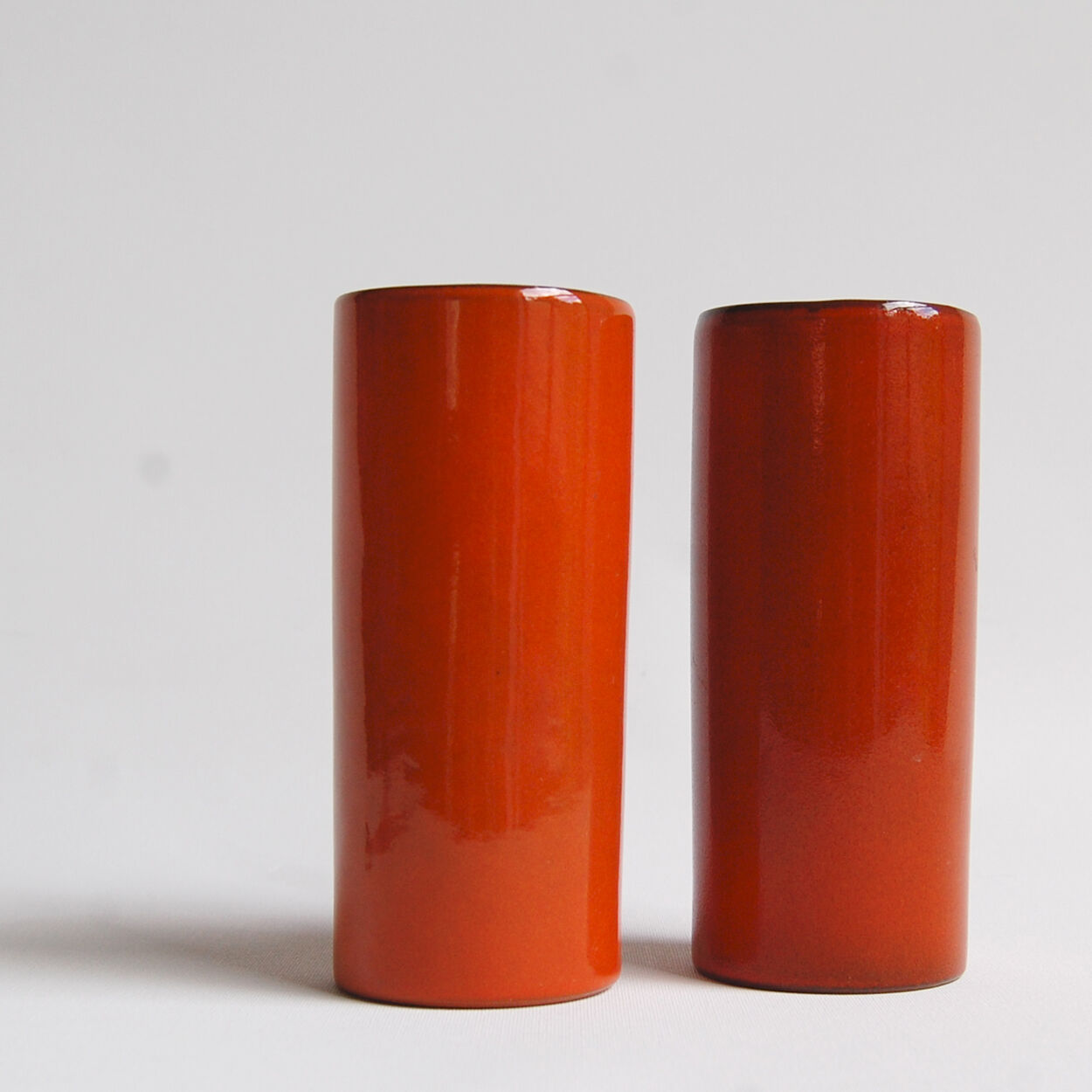 Pair of orange roll vases