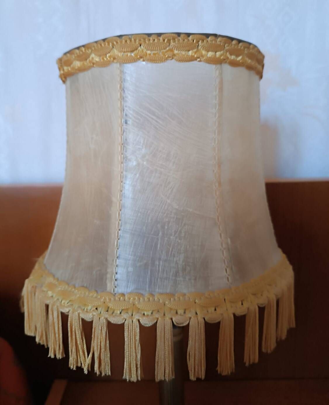 Brass bedside lamp with natural bladder shade.
