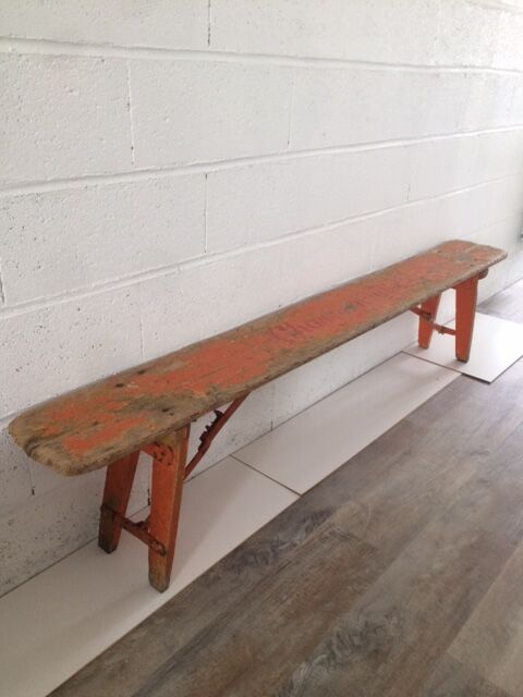 Orange folding wooden bench