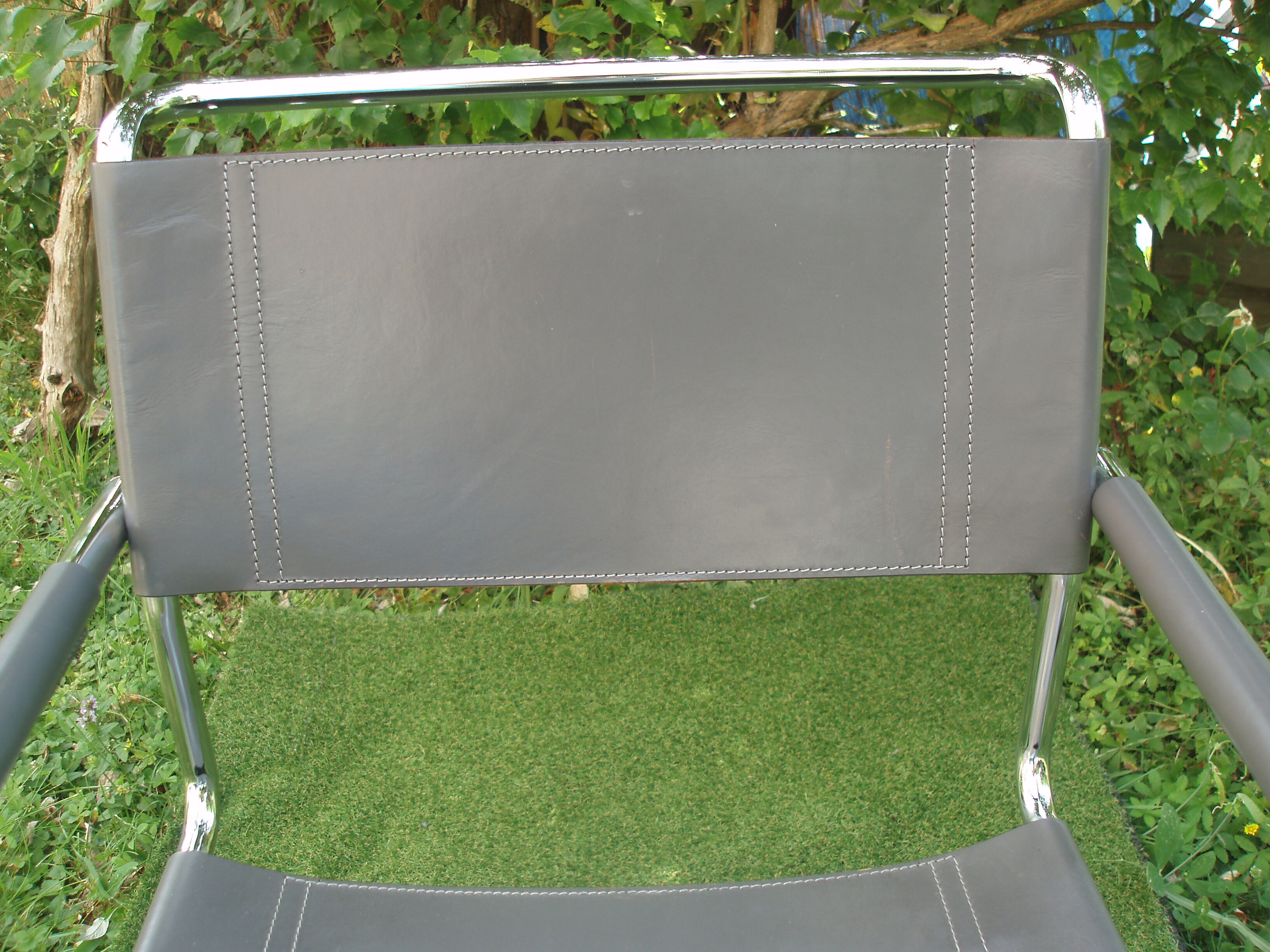 Series of grey and chrome leather armchairs