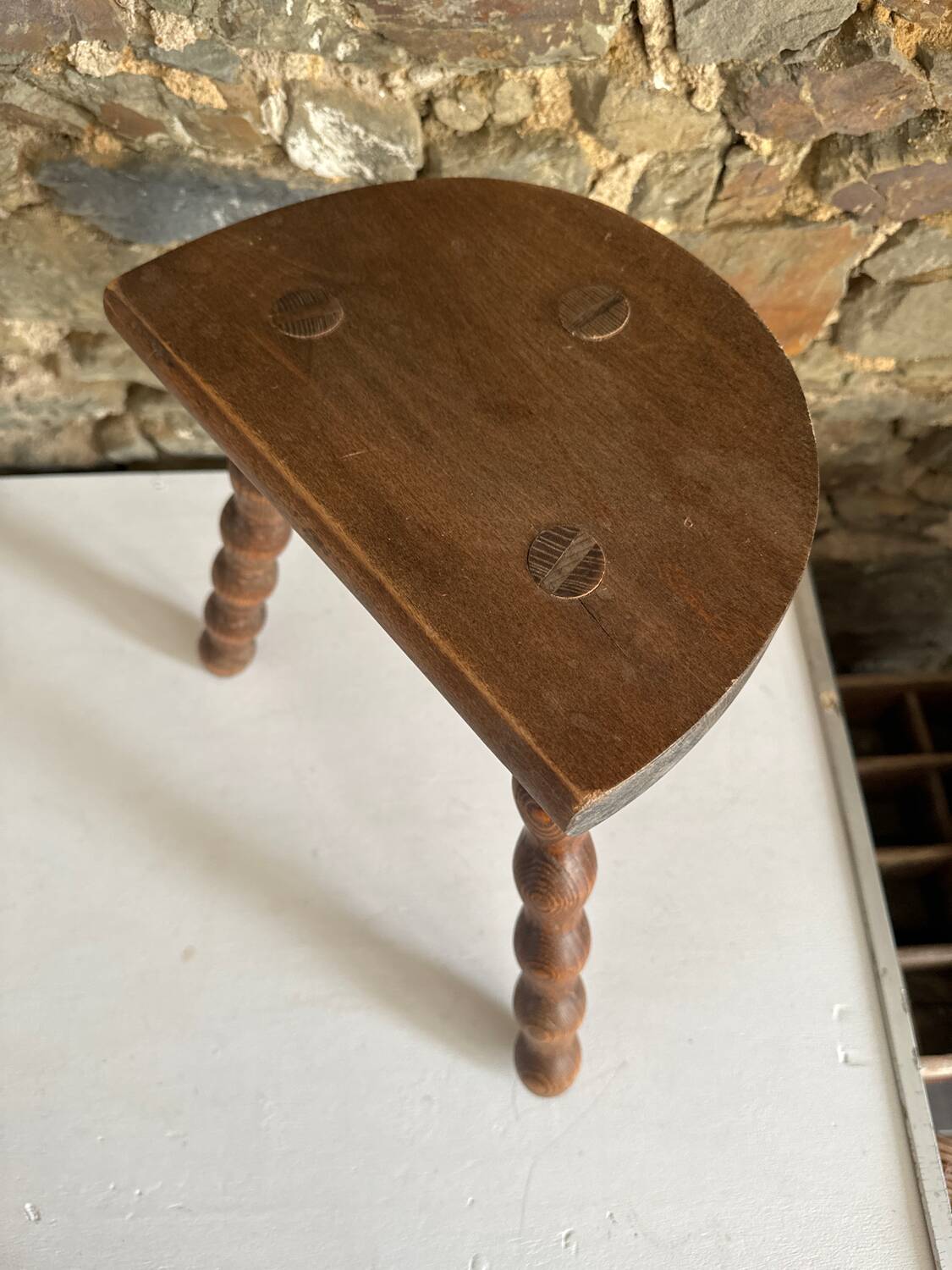 Low tripod stool with turned legs