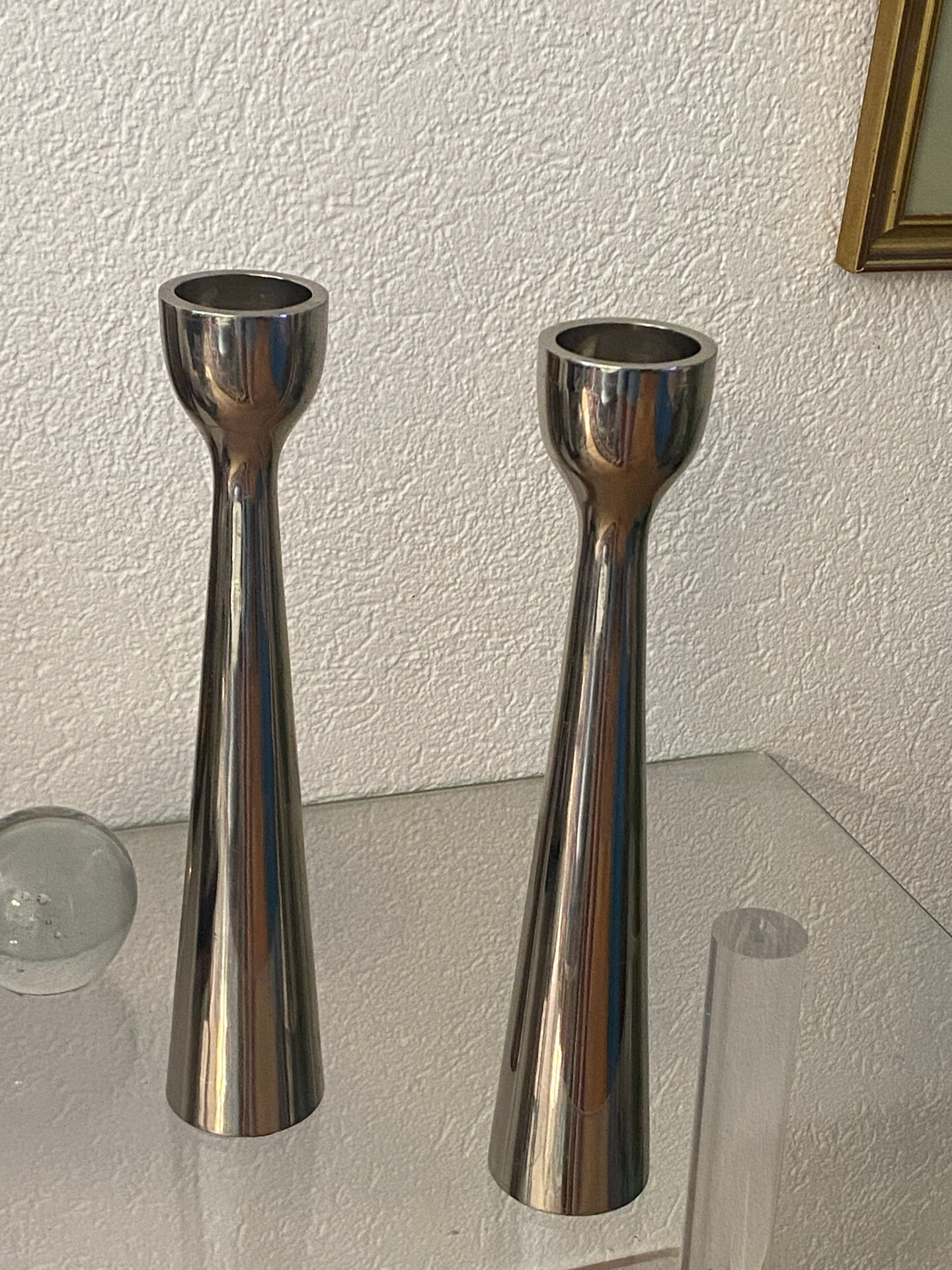 Pair of polished aluminium candlesticks