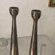 Pair of polished aluminium candlesticks