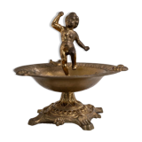 Vintage brass ashtray from the 1940s with a nude boy figurine on a footed base.