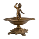 Vintage brass ashtray from the 1940s with a nude boy figurine on a footed base.