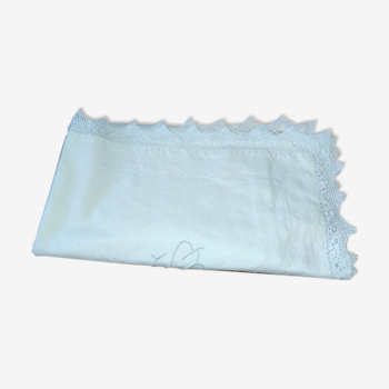 Ancient monogrammed pillowcase adorned with cotton lace