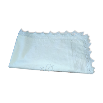 Ancient monogrammed pillowcase adorned with cotton lace