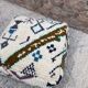 Berber floor pouf: Handwoven Moroccan wool cushion.