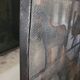 Black metal firewall decorated with animals