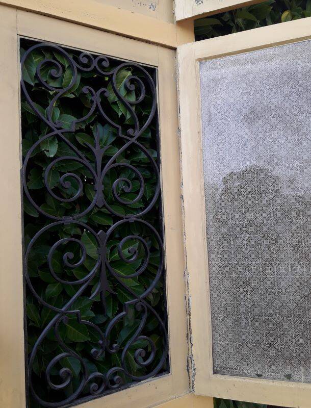 19th century double arched entrance door in oak with grilles and old glass