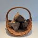 Woven Rattan Log Holder in a Semi-Round Shape with a Central Arched Handle.