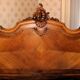 Walnut rocaille bed from the early 20th century.