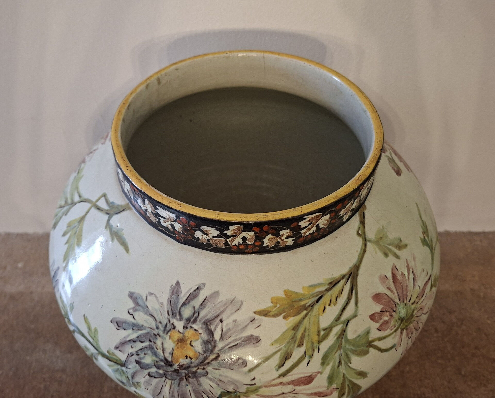 Large polychrome ceramic cache-pot with floral decoration.
