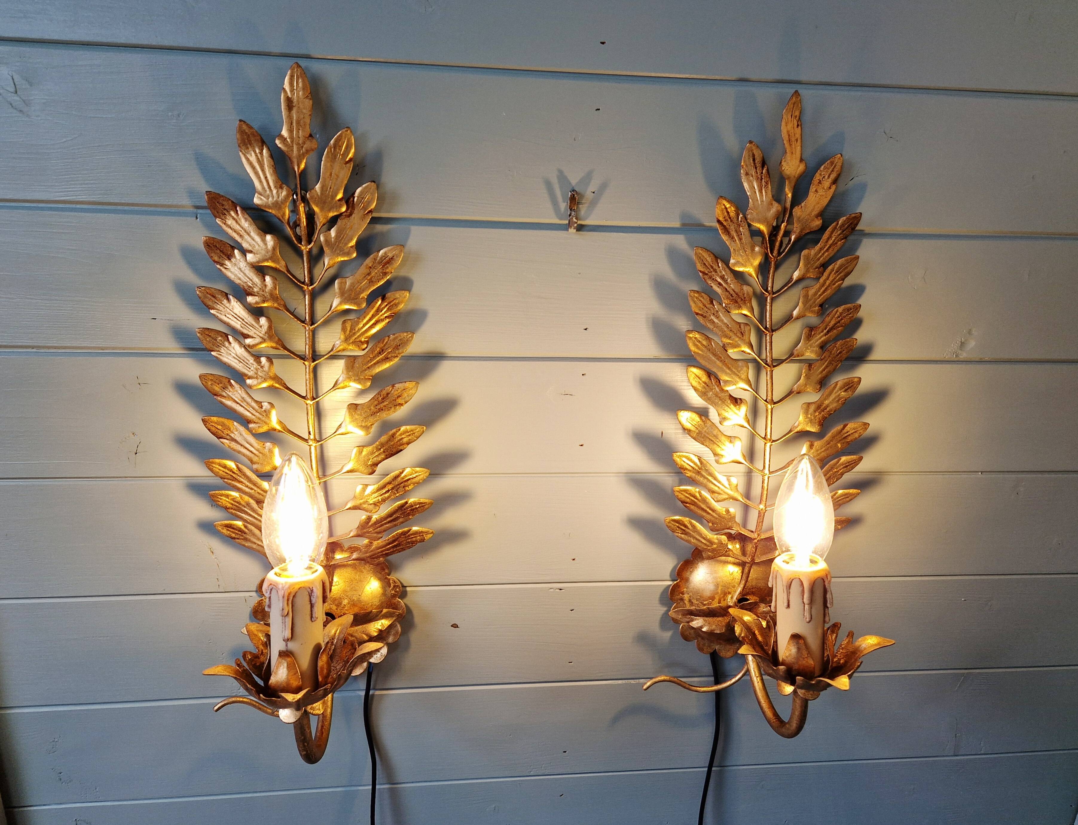 Pair of gold metal wall sconces in Hollywood Regency style, 1970s.
