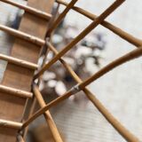 Rattan cradle with arrow