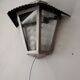 Half grey metal wall sconce and 3 windows