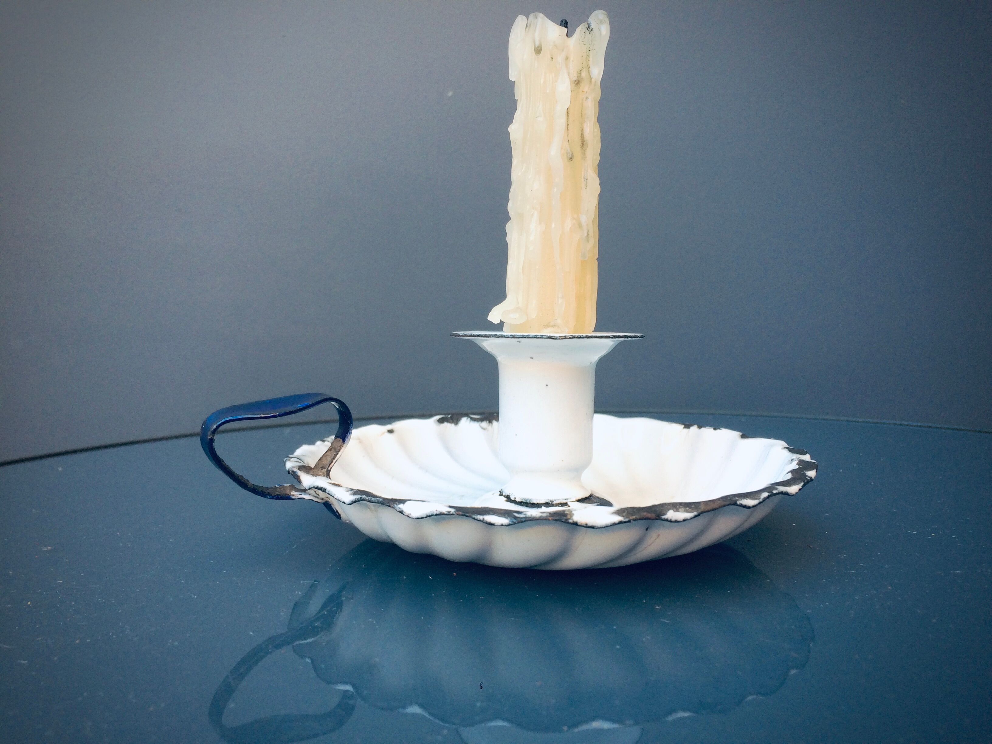 Old white enamelled candlestick