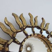 Golden wooden sun mirror with inlays from the early 20th century.