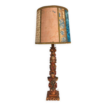 Renaissance table lamp in polychrome carved wood with cherubs.