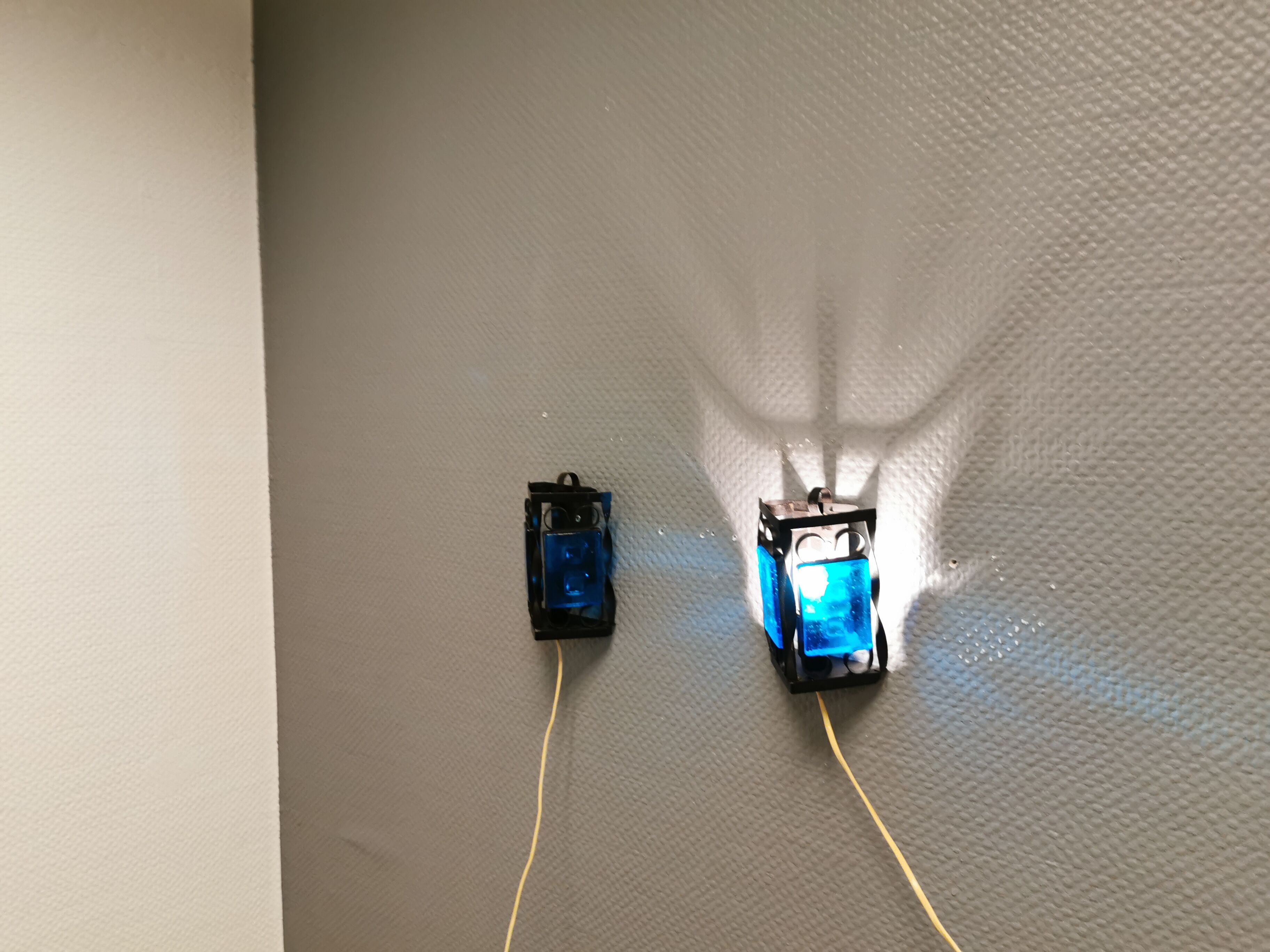 Wall lamps made of black cast iron and handmade thick pressed blue glass