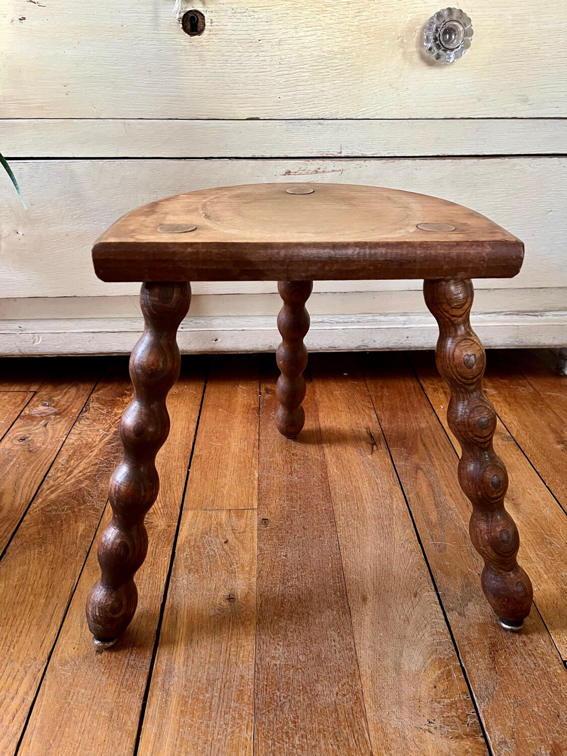 Low vintage wooden tripod stool