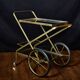 Vintage rolling trolley in gold metal & smoked glass – Retro elegance as
