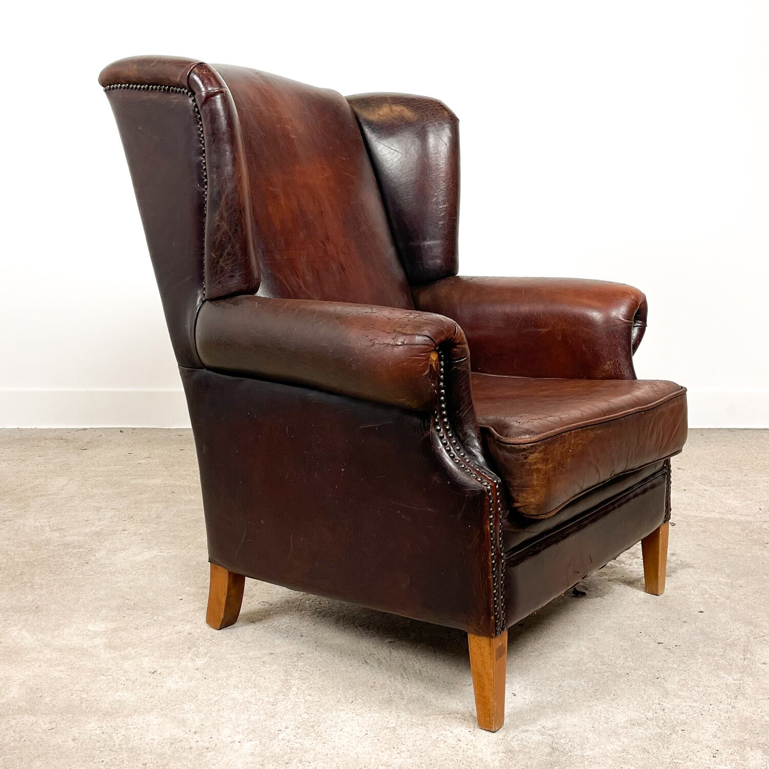 Dark brown vintage sheep leather wingback armchair